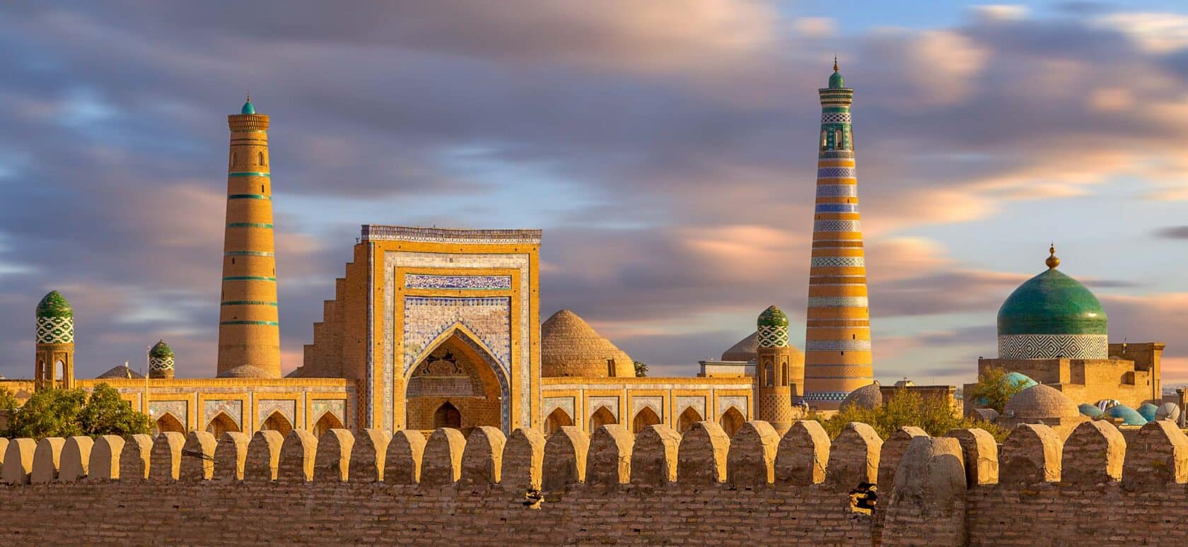 View over the skyline of the ancient city of Khiva, Uzbekistan at sunset.
