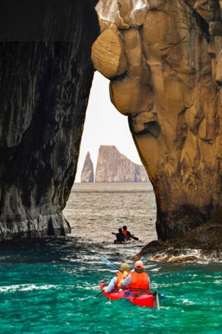 Tourists sea kayaking in the Galápagos Islands.