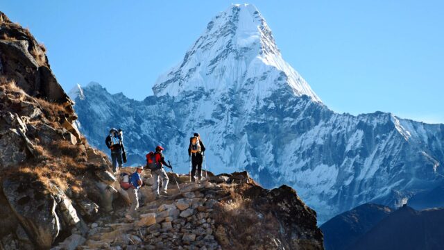 A group of travelers on a hike in mountains in Nepal.