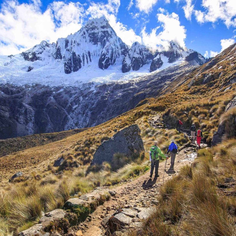 A group of people hiking a mountain range in Peru.