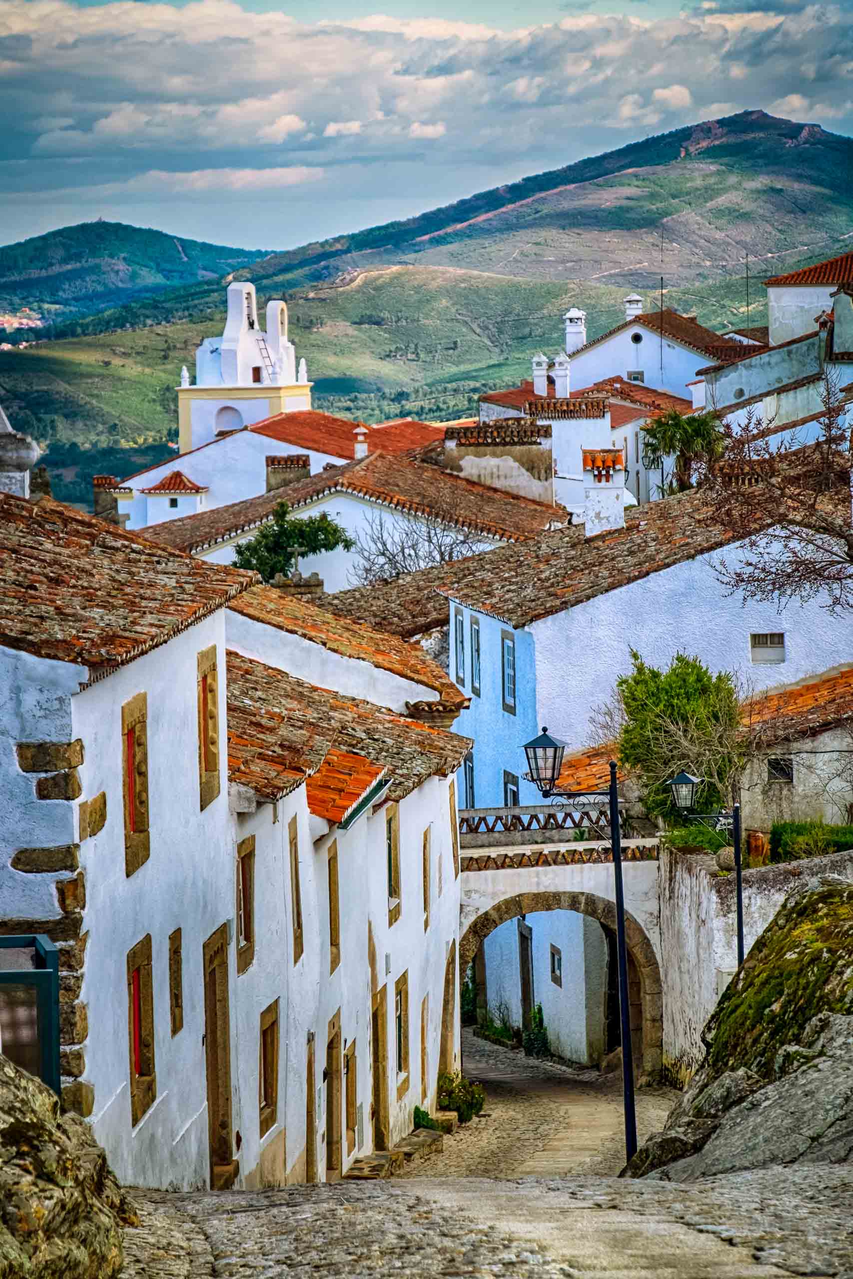 Old white houses on a street in Portugal.
