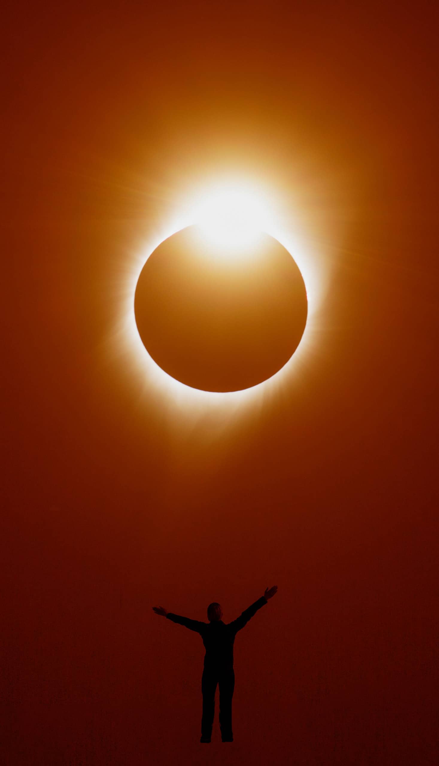 Woman enjoying sight of a solar eclipse.