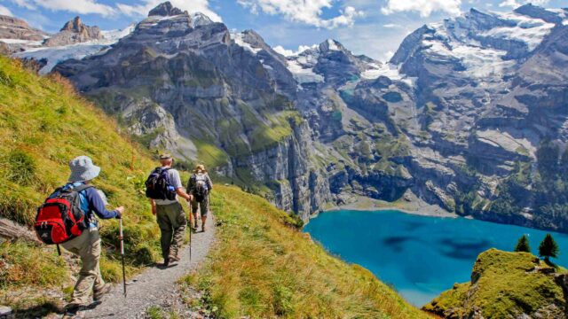A group of people hiking mountains in Switzerland.