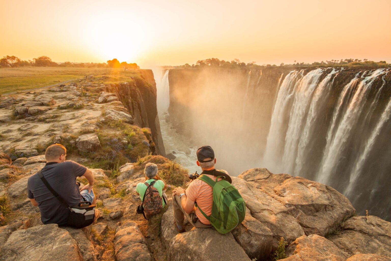 A group of travelers observing Victoria Falls.
