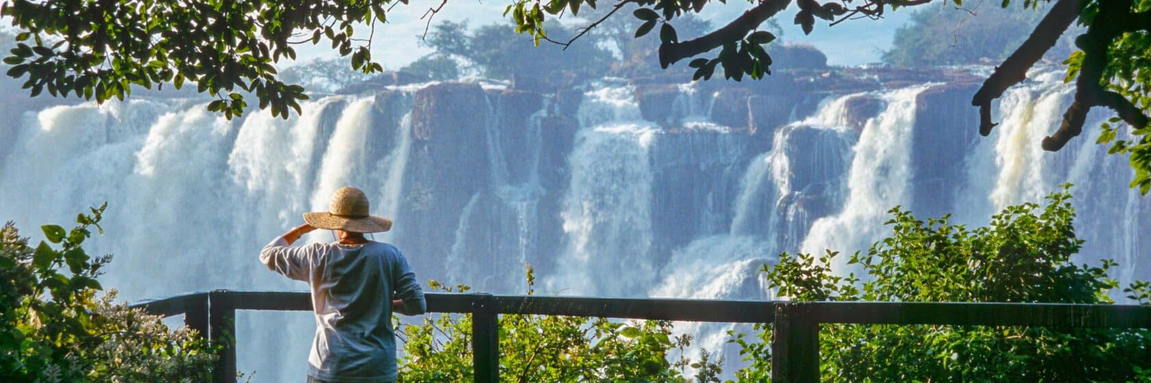 A tourist watching a waterfall in Zimbabwe.